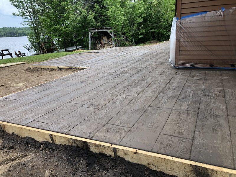 Barnwood plank stamped patio at a lakefront cabin