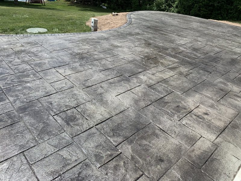 Large Grand Ashler stamped patio with curved cobblestone border
