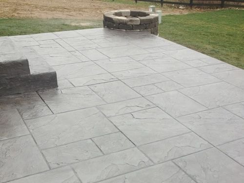Stamped slate patio with stone fire pit