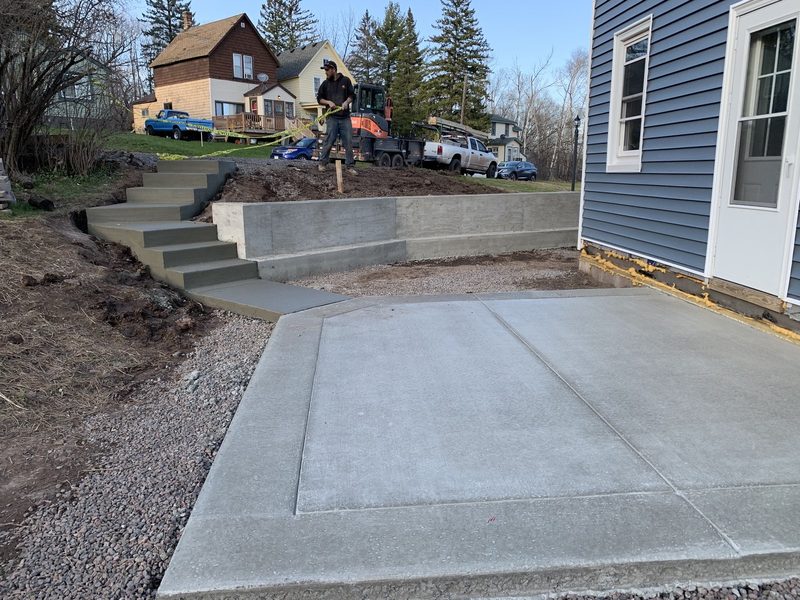 Multi-tier hardscape with patio, retaining wall, and stairs