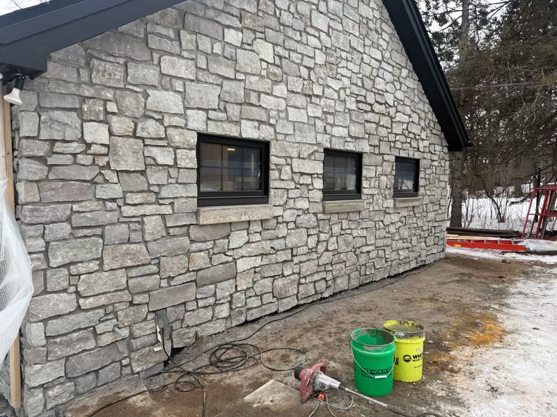 Custom exterior stone wall on a high-end home