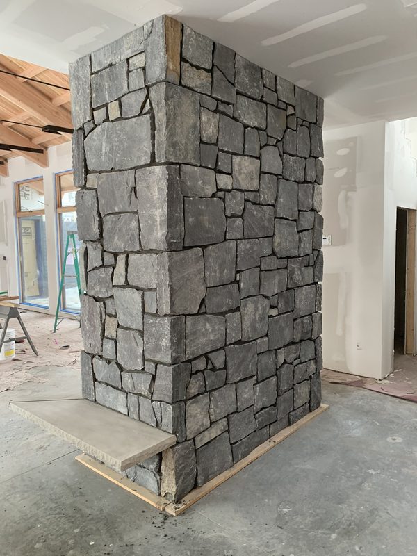 Two-sided stone fireplace showing full construction