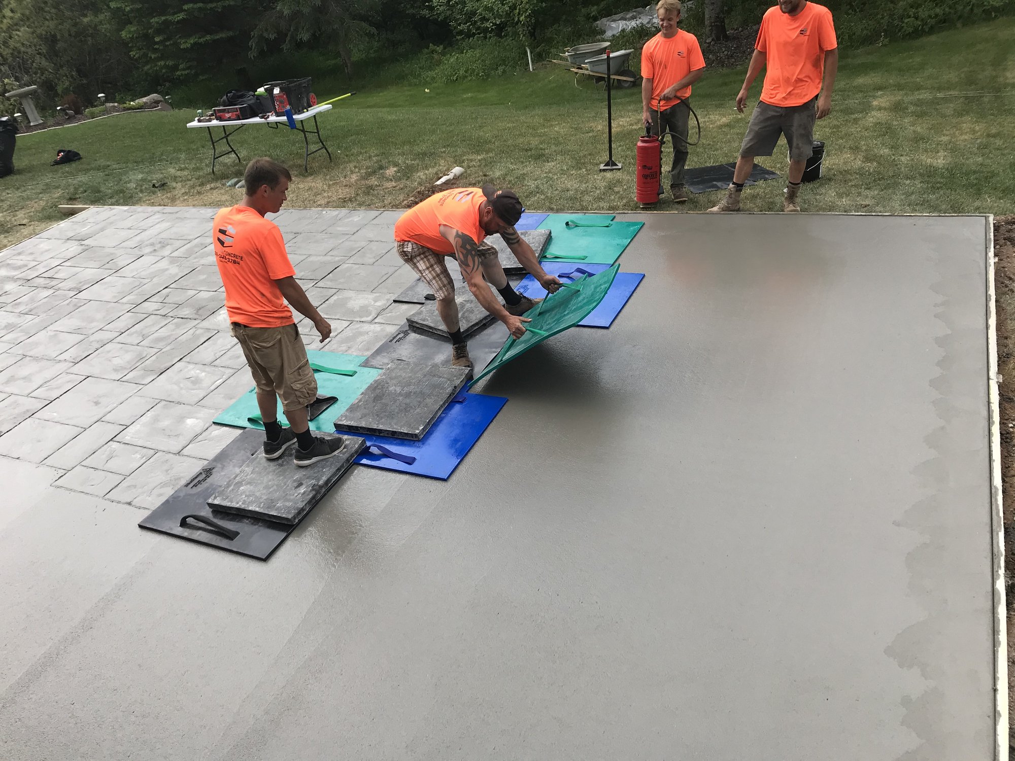 Primetime Concrete crew stamping a custom decorative patio